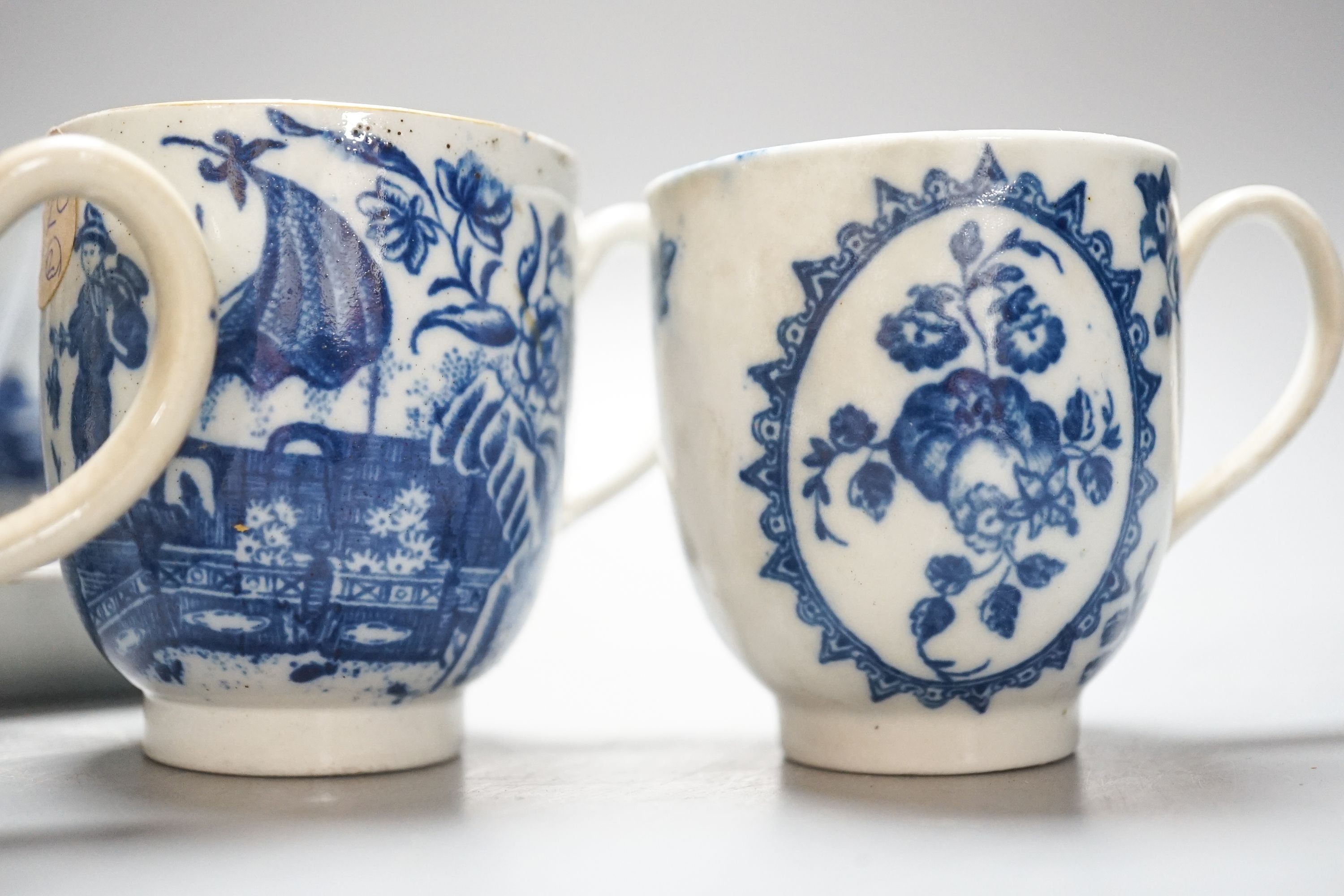 A group of Worcester and Caughley blue and white tea and coffee wares, late 18th century including fisherman pattern, three flowers pattern, chinoiserie figures etc.